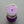 A top-down view of Everlong Candle Co.'s Let's Go Disco candle, showcasing its vibrant purple eco-glitter covering the coconut-soy wax surface. Glitter is sustainably made from eucalyptus trees. Features: crackling wood wick, clear glass jar reveals its 70s-inspired label with bold typography and wavy stripes. Beneath the candle, a purple disco ball adds playful, nostalgic touch.