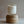 Everlong Candle Co. Desert Oasis candle (13oz) on a wooden stand.  Retro-inspired label with orange stripes. Vegan coconut-soy wax, crackling wood wick.